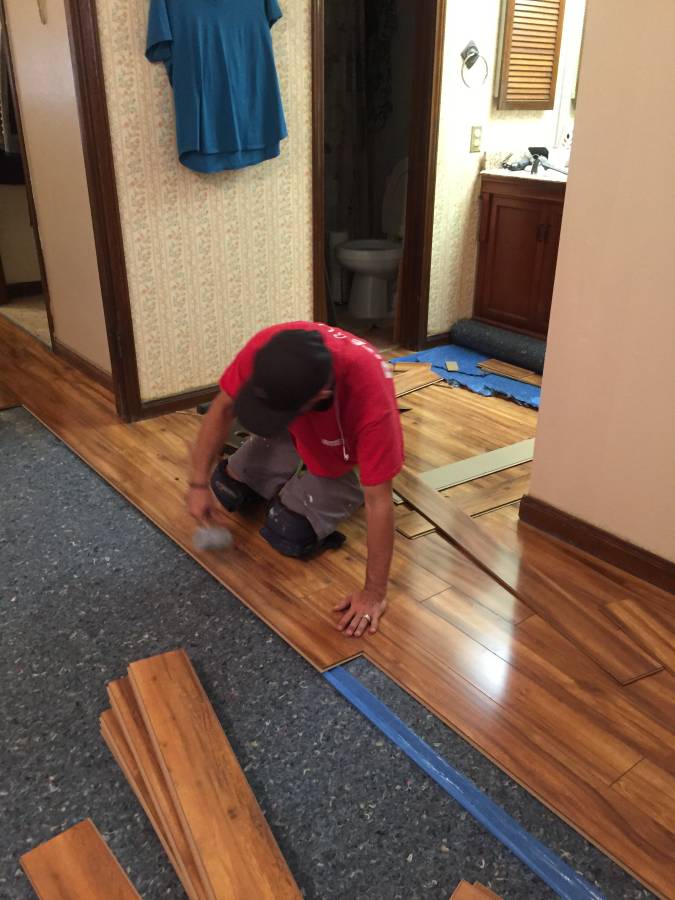 A man installing new laminate flooring