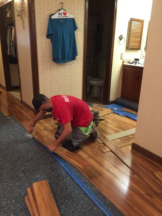 A man installing new laminate floors