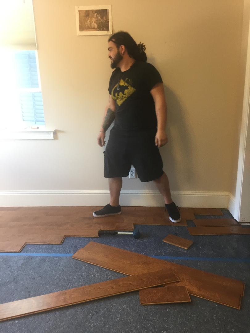 A man installing new vinyl plank flooring